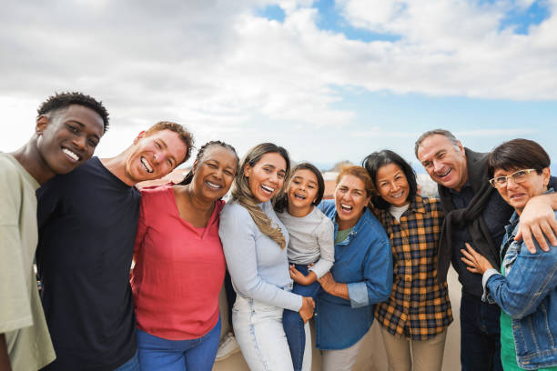 group-of-multigenerational-friends-smiling-in-front-of-camera-multiracial-friends-of (1)